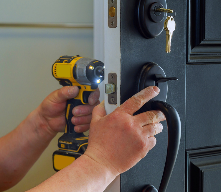 person installing a door knob in St. Charles home