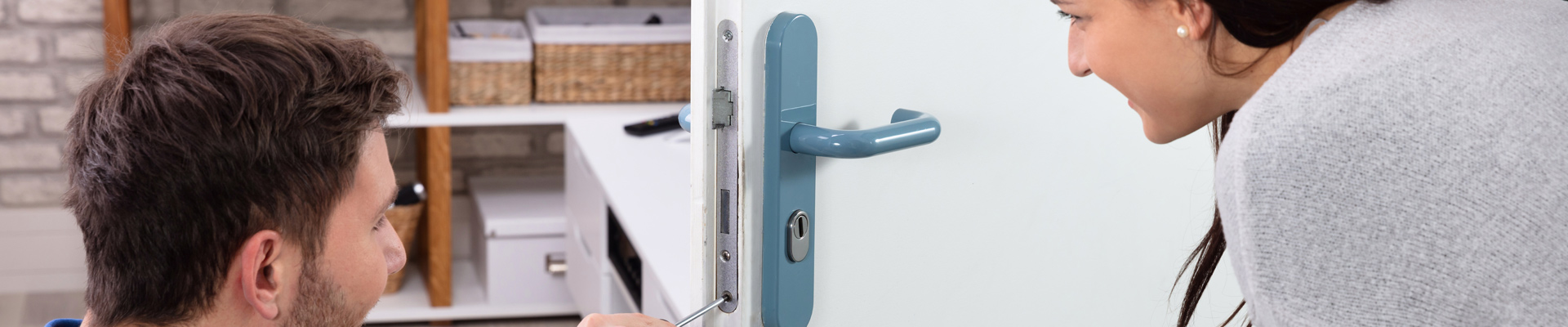 man and woman inspecting new lock installation