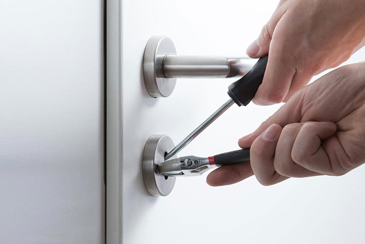 picking door lock with professional locksmith tools