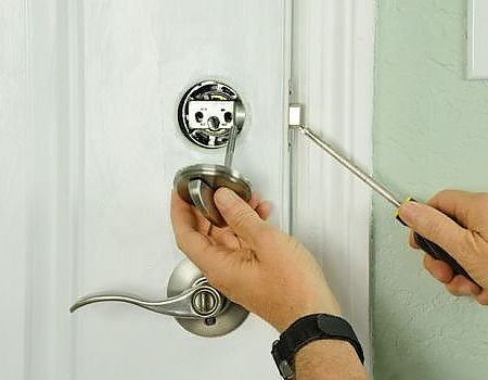 inserting a key into a residential door lock in St. Peters